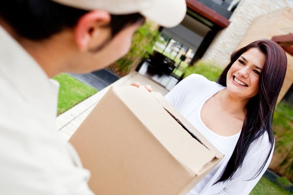 Mailman delivering a parcel at a womans house